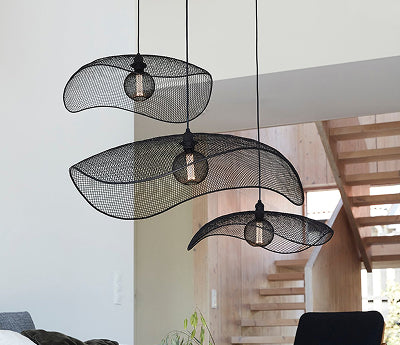 Svarta nätformade taklampor hängande i trappa med naturligt ljus